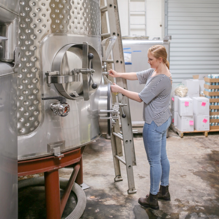 Colleen Sullivan pouring wine from her barrel