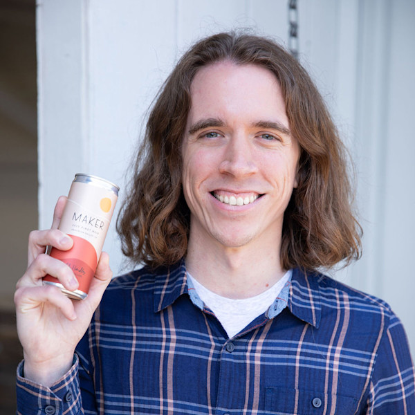 Headshot of Gus Childs, Lead Engineer with a Maker can.