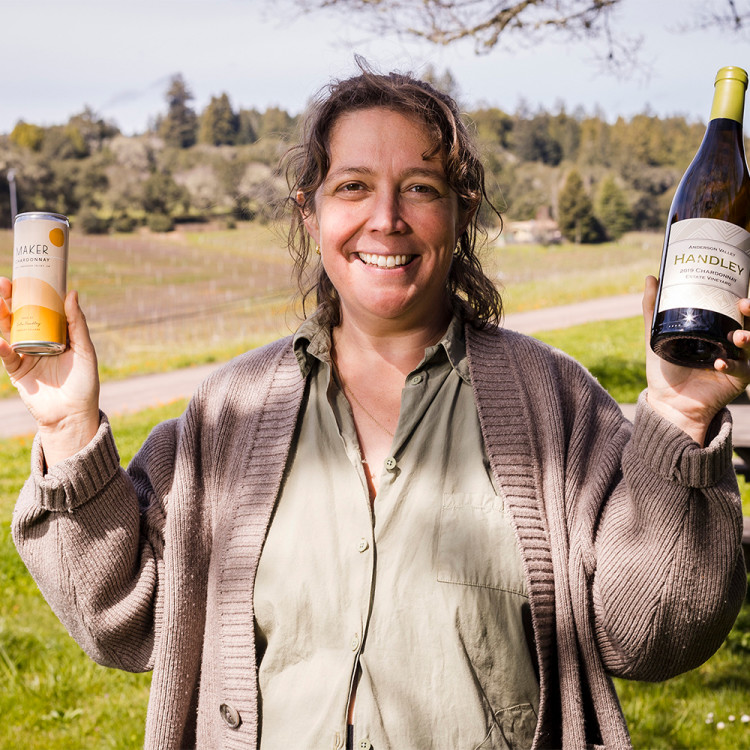 Lulu Handley holding a can and bottle of Chardonnay.
