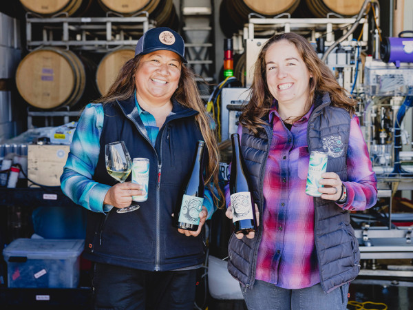 Tara & Mireia of Camins 2 Dreams holding bottles and Maker Wine cans of their Albariño.
