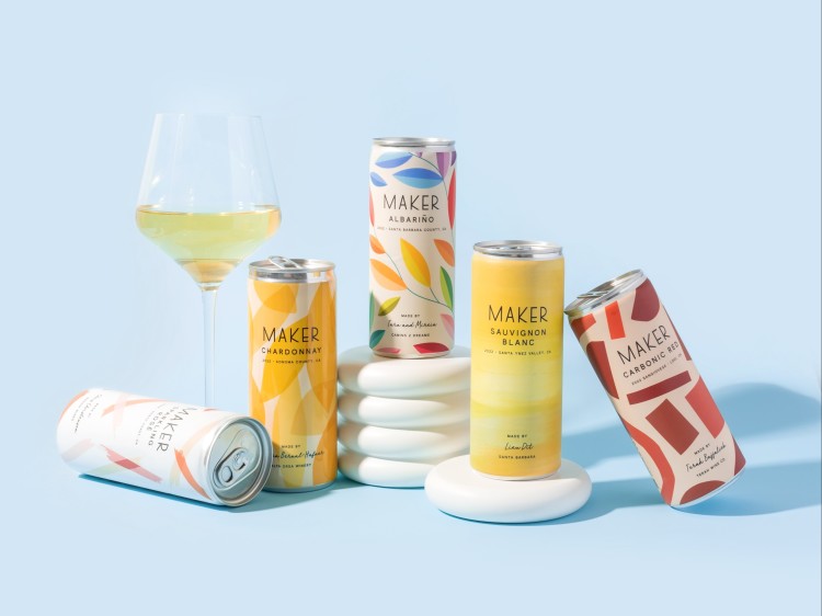 5 maker cans with glass of white wine on blue background