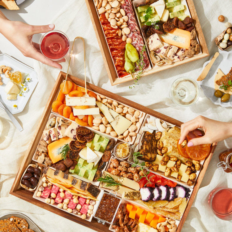 Terza Cheese snack board with hands reaching for food