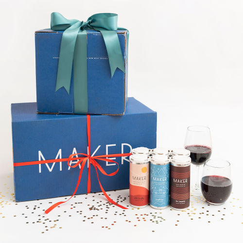 Gift boxes with Maker's Premium Canned Red Wines and glassware.