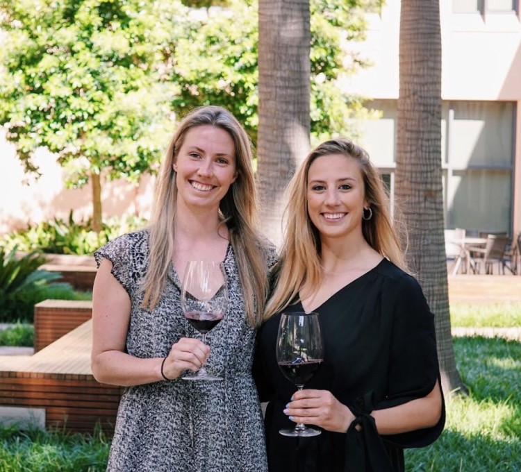 Sarah and Kendra, founders of Maker Wine with wine glasses in wine