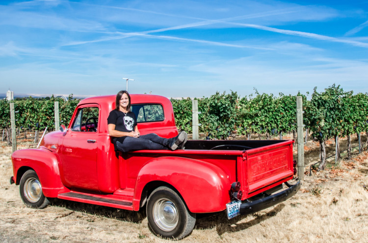 Annette Bergevin, Founding Partner of Bergevin Lane Vineyards on a red truck. 