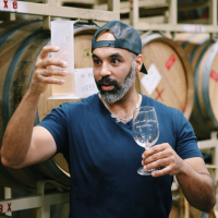 Christ Christensen, Maker winemaker, with beaker and wine glass 