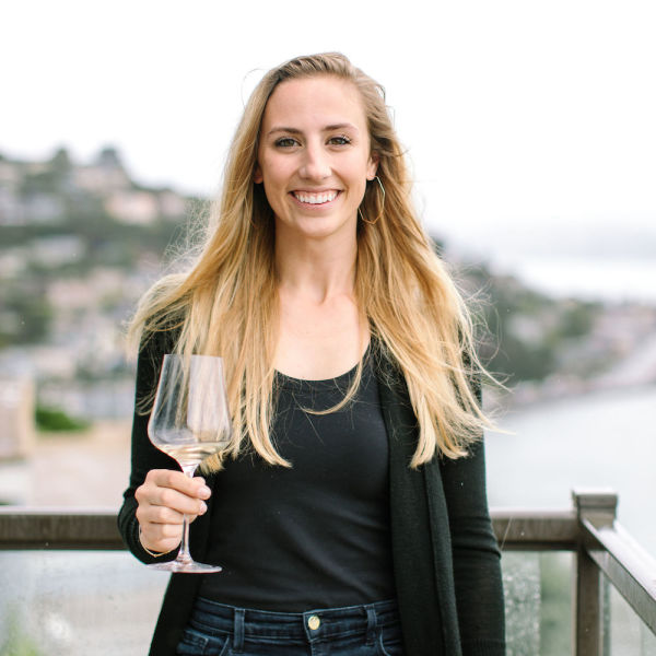 Kendra Kawala, co-founder of Maker Wine with a glass of white wine.