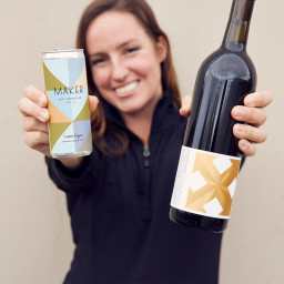 Gianna Fugazi of Wander-Must Wine holding a can and bottle of Verdelho.