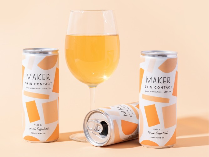 three cans of orange vermentino with glass orange wine