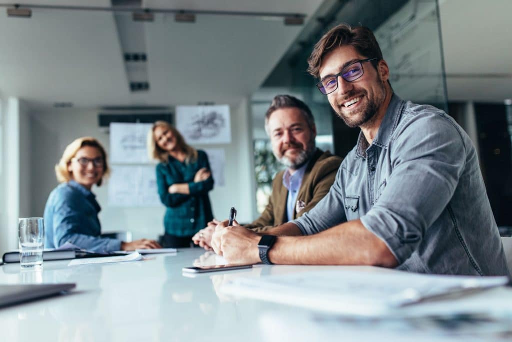 4 people smiling in a meeting