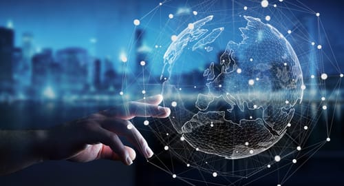 a hand pointing at a hologram of the globe