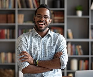 a man smiling in an office