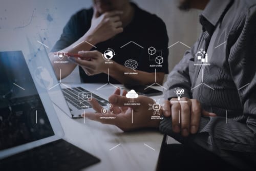 2 men discussing workwith digital icons overlayed