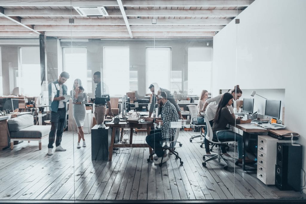 a group of people on computers in an office