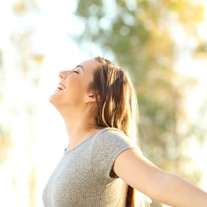 a woman standing in the sun