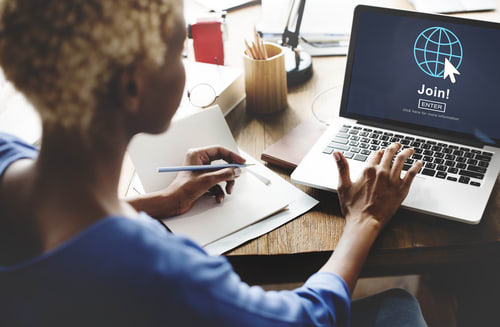 a woman typing on a laptop