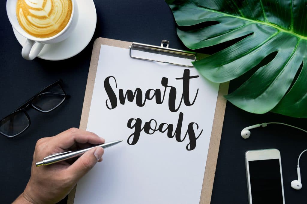 Writing "smart goals" on a clipboard