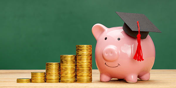 stacks of gold coins with a piggy bank