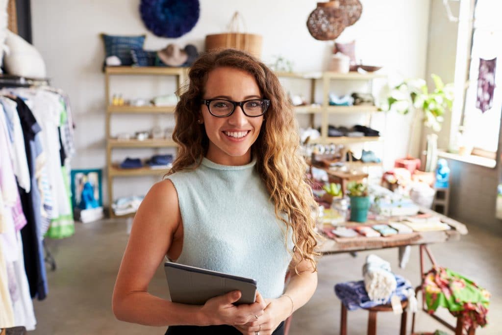 a boutique fashion shop owner standing in their shop