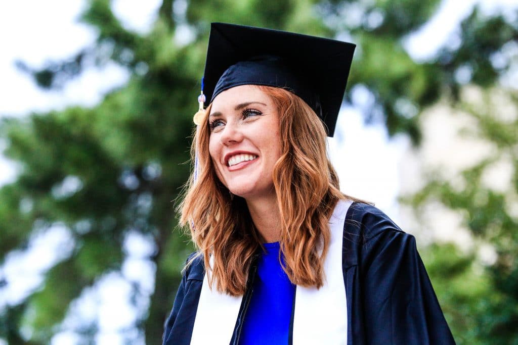 a student on a graduation gown and hat