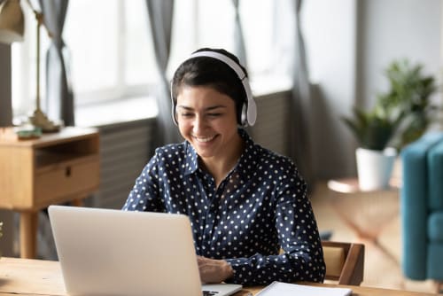 a girl on a laptop with headphones