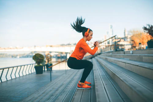 a woman exercising on a staircase