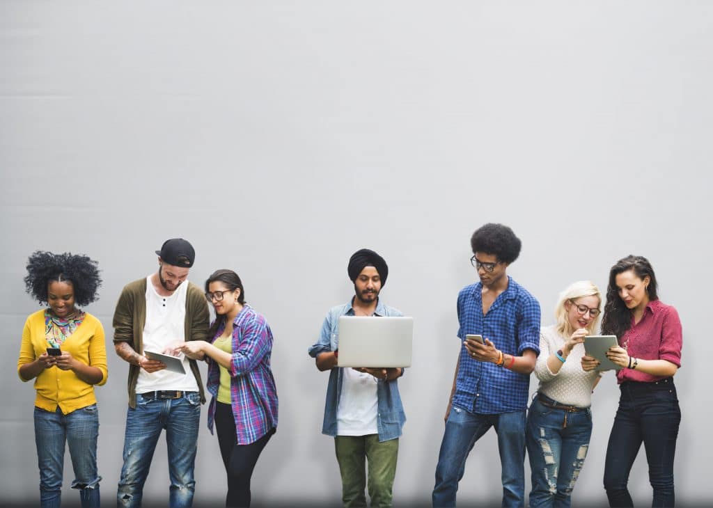 7 people standing and discussing work