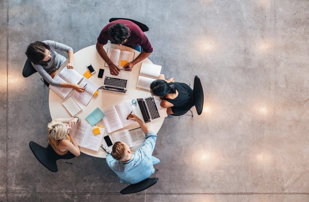 5 people working around a circular table