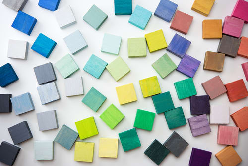 coloured tiles scattered across a white surface