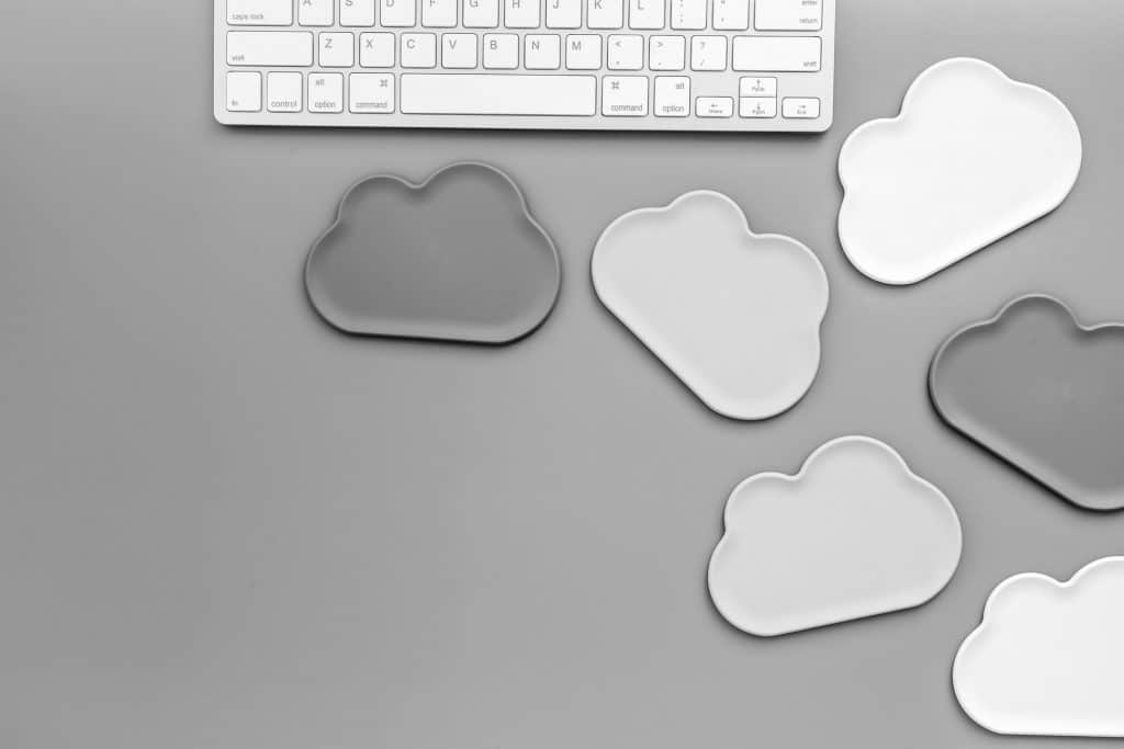 Mac keyboard with cloud shapes around it