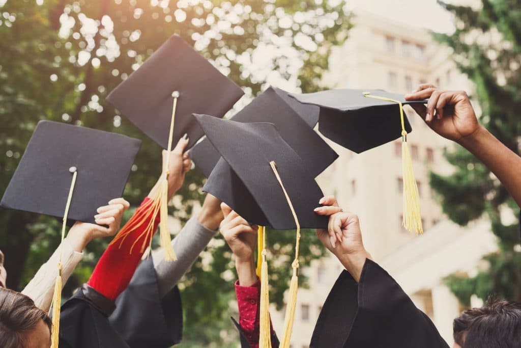 graduation hats being thrown in the air
