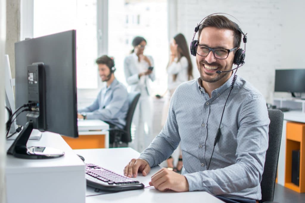 call centre support staff smiling at their desk