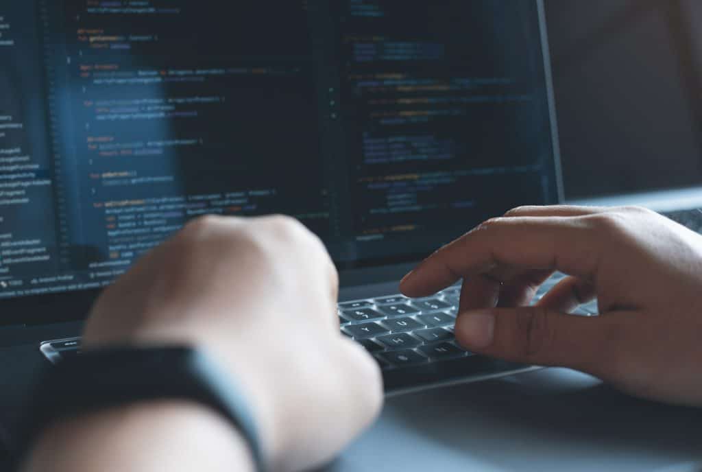 typing code on a laptop