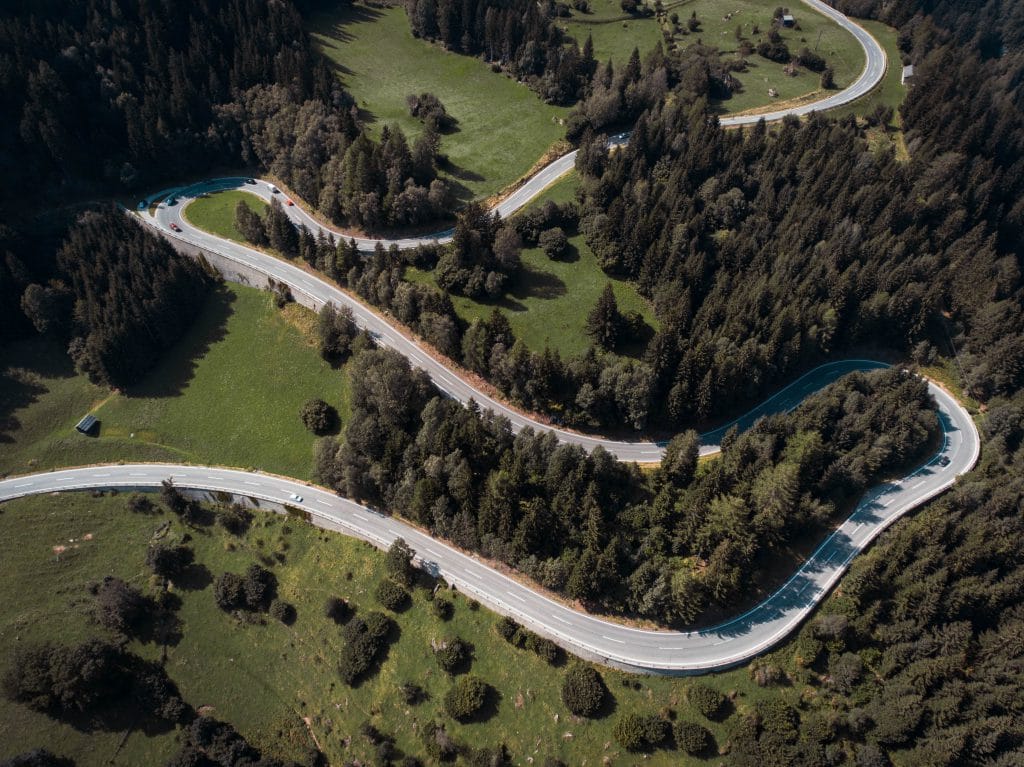 a winding road through a country hillside