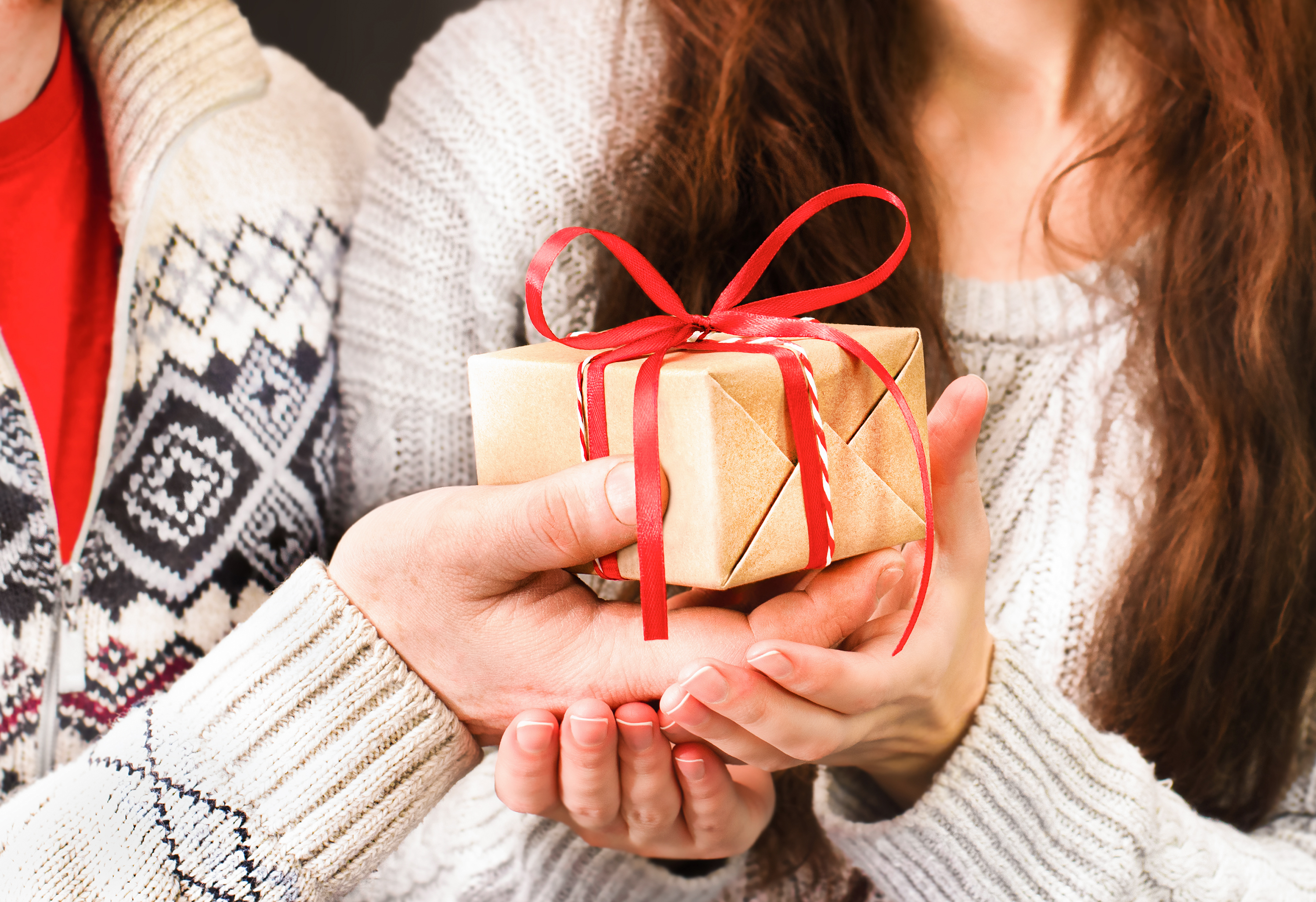 Couple holding small christmas gift