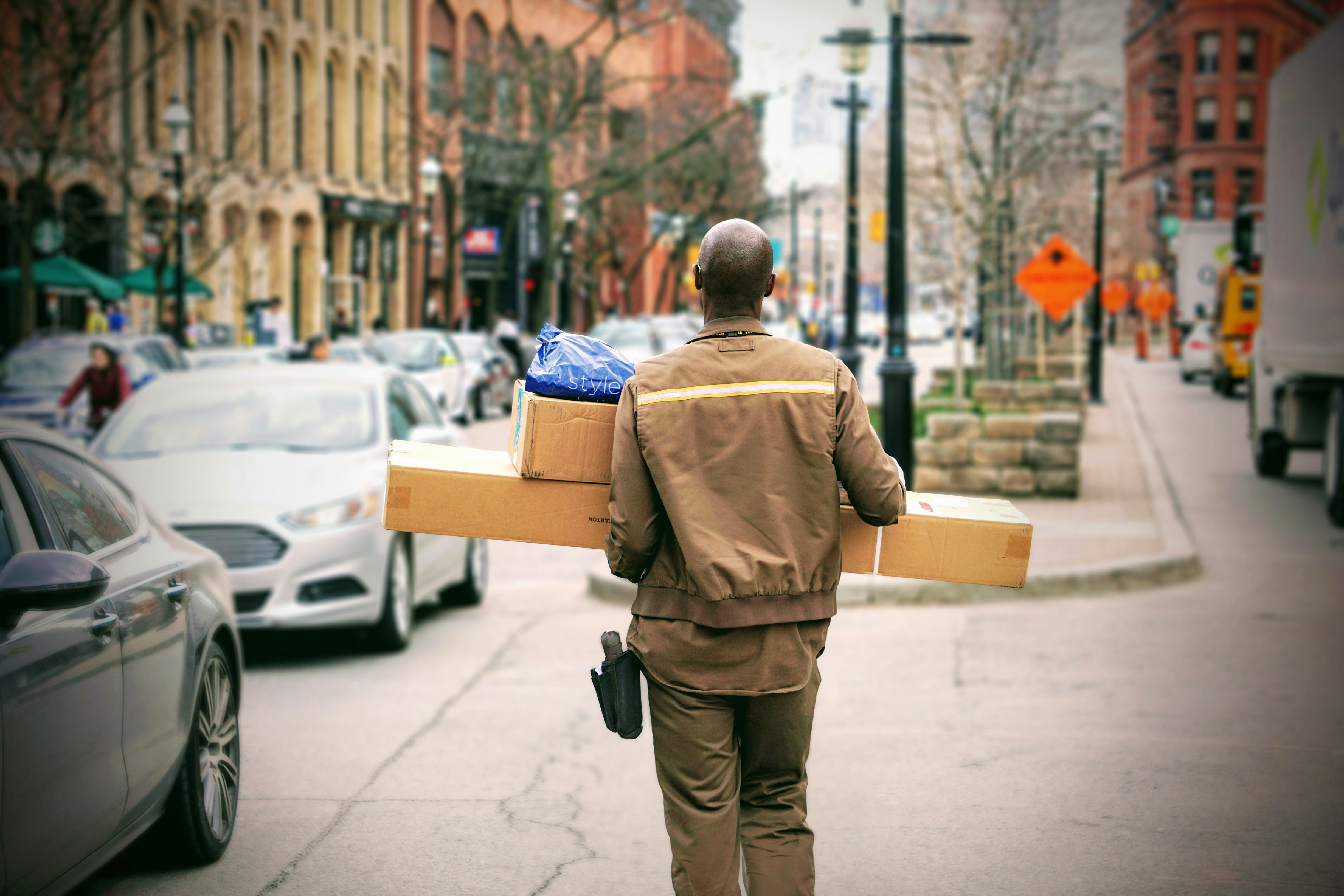 Delivery person carrying parcels