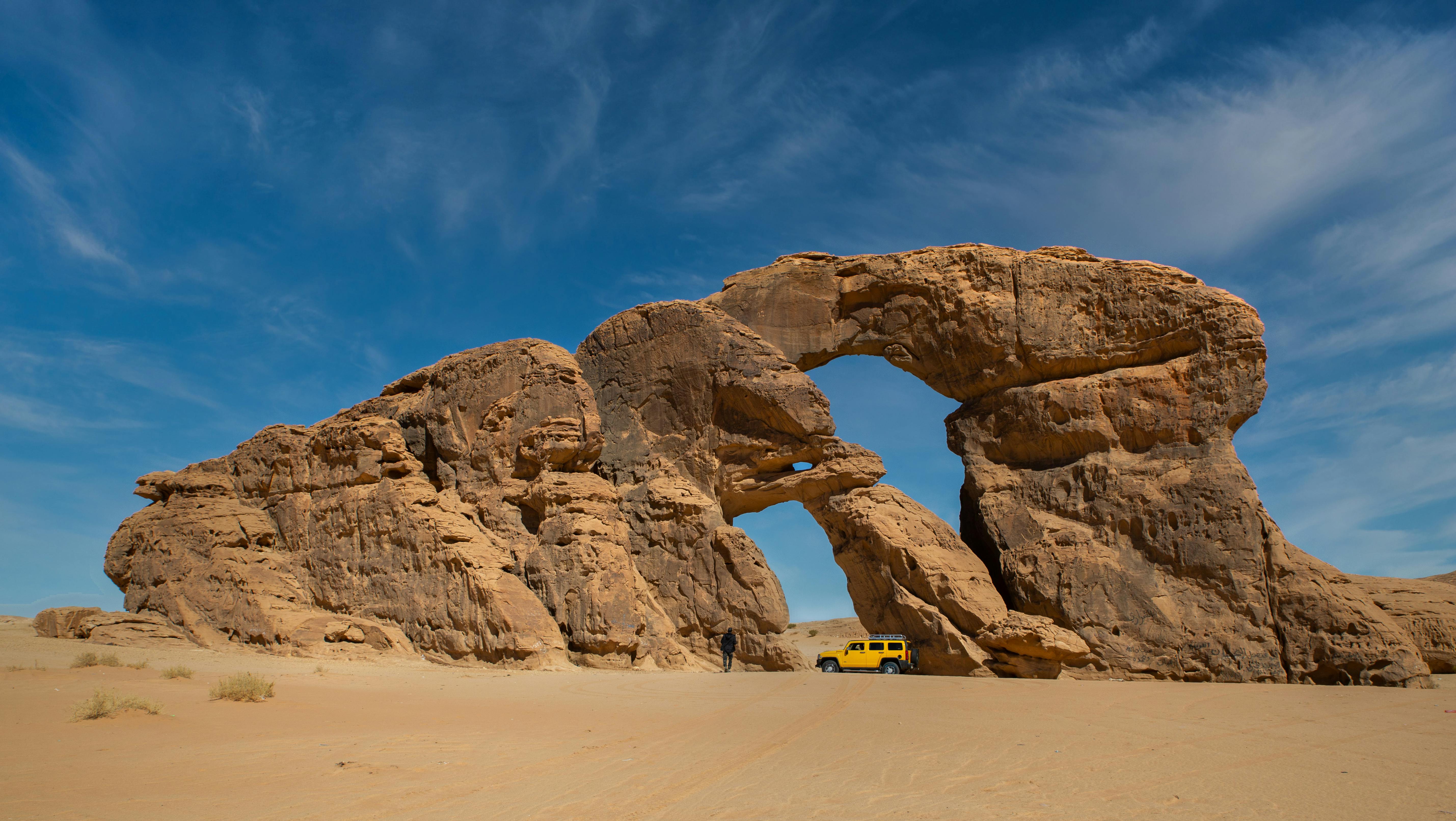 Jeep under Rock Formation in Chad