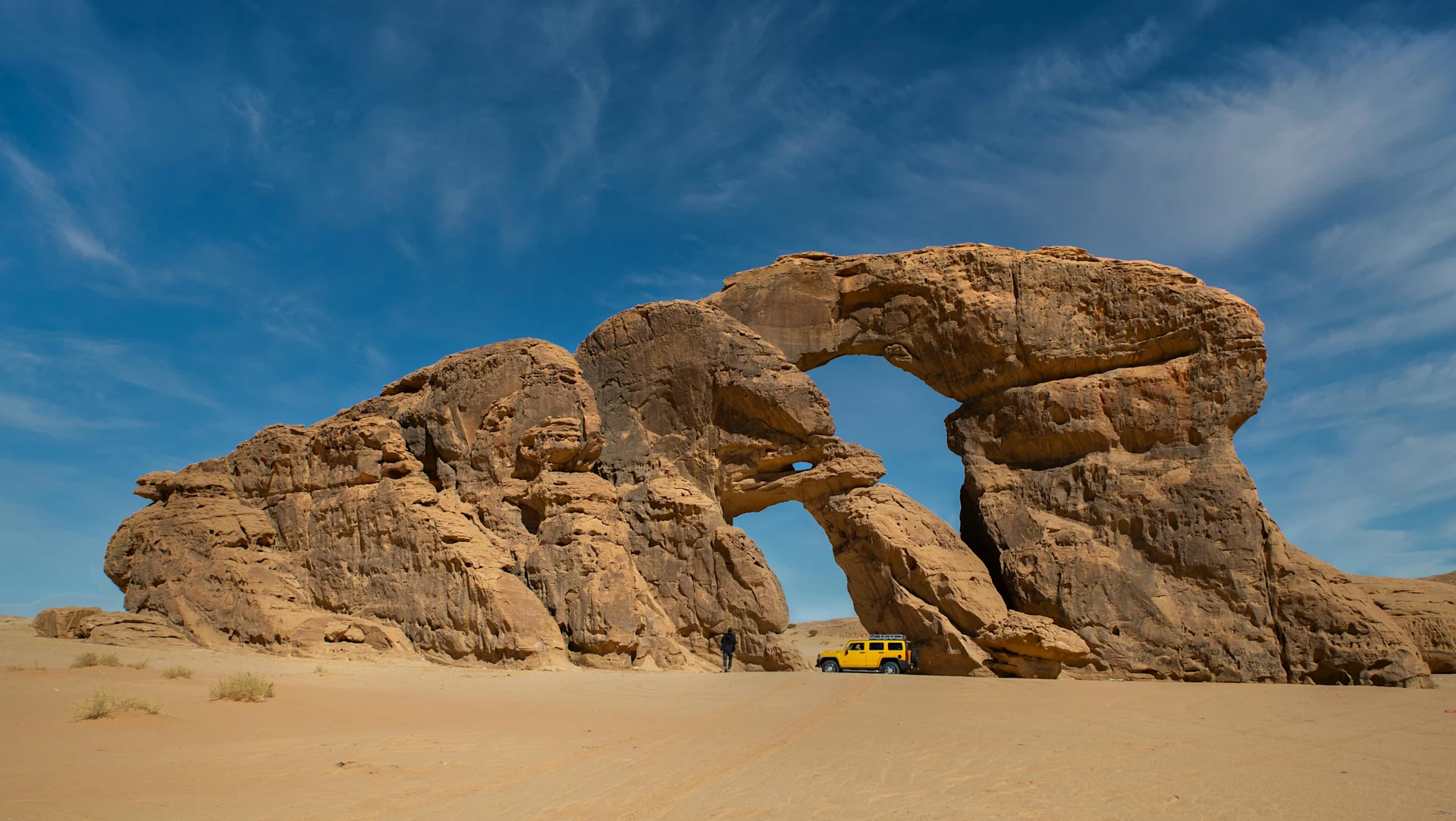 Jeep under Rock Formation in Chad