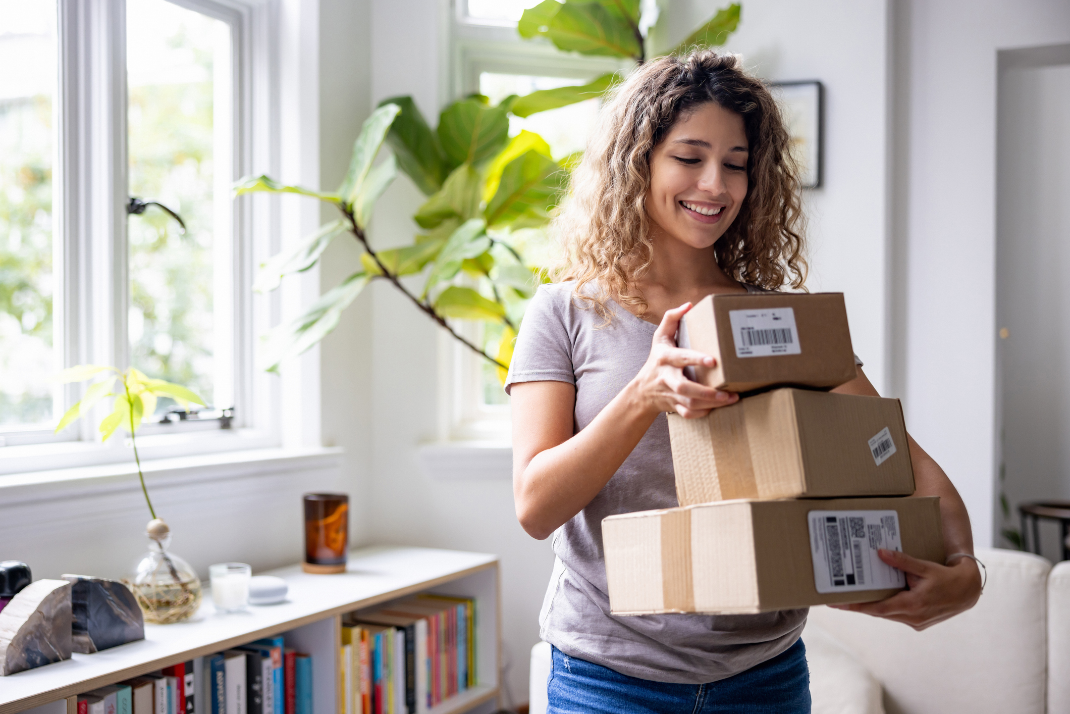 Woman holding stack of parcels