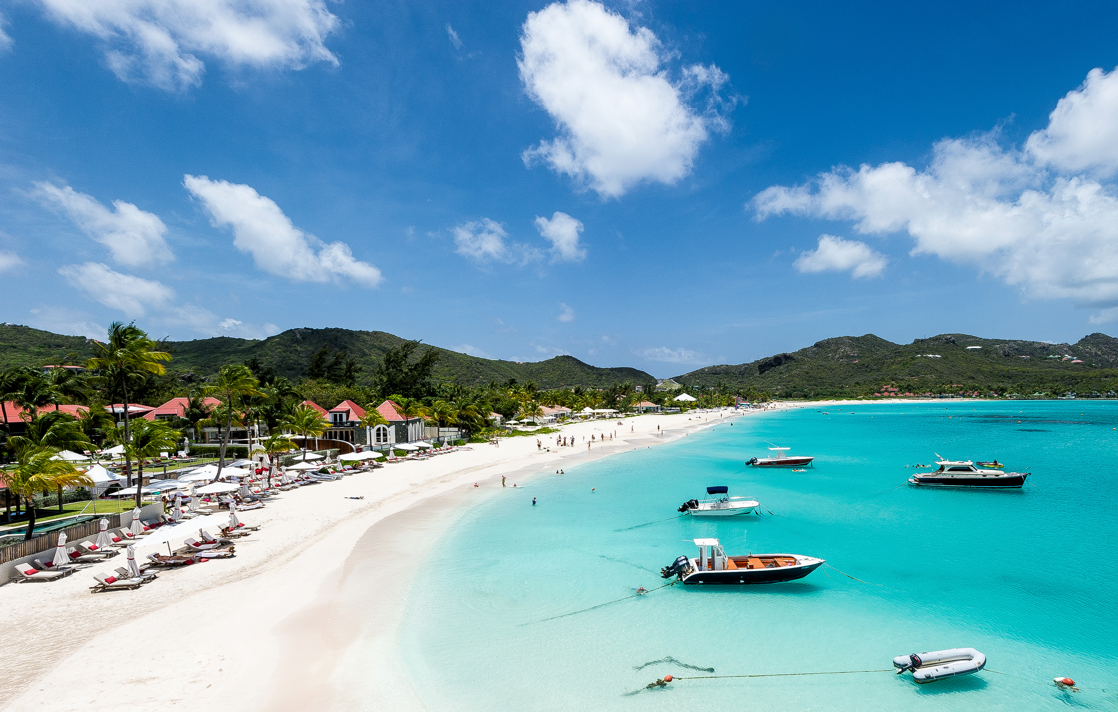 Beach, huts and green mountains in St. Barthelemy