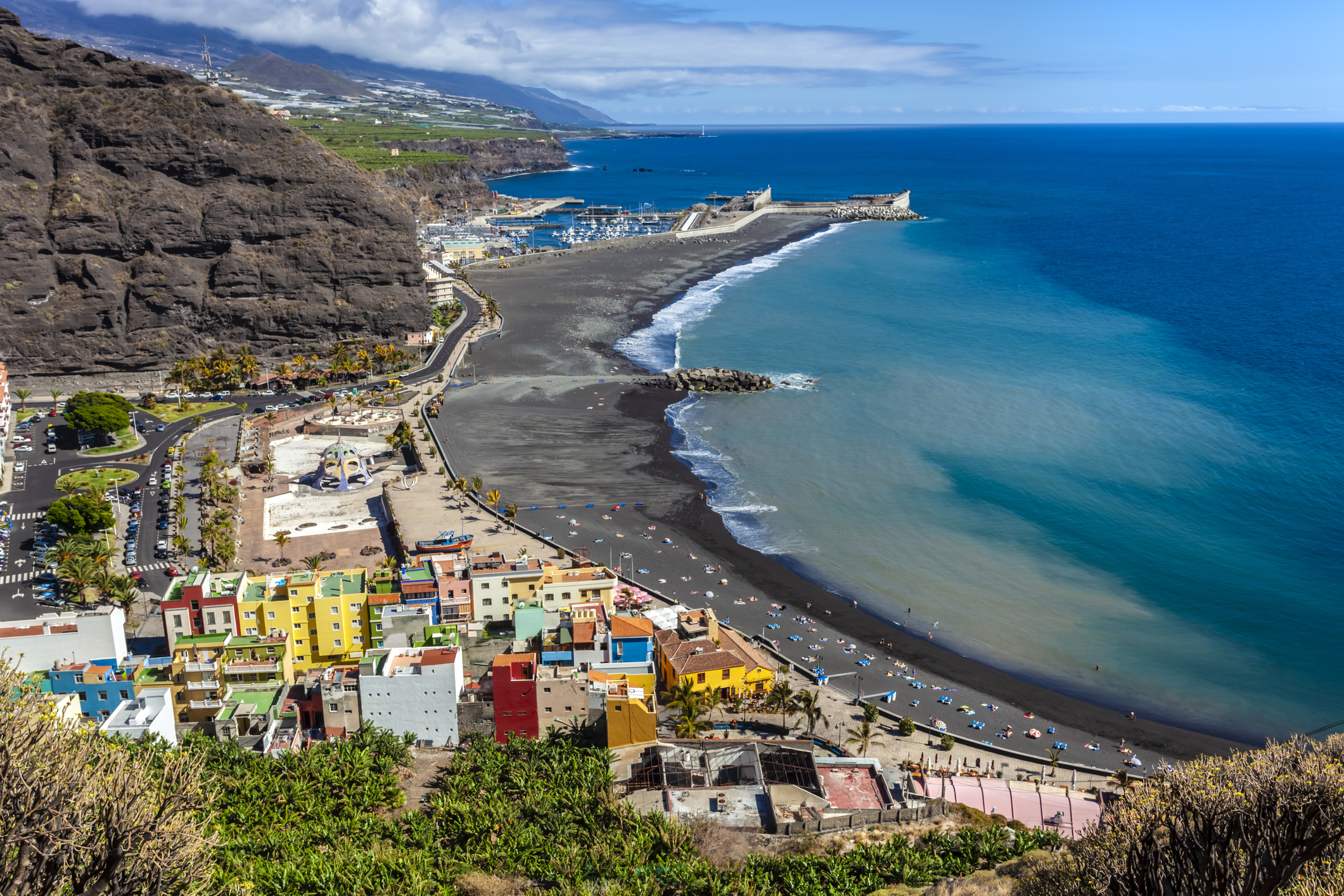 Colourful La Palma houses overlooking a dark blue body of water
