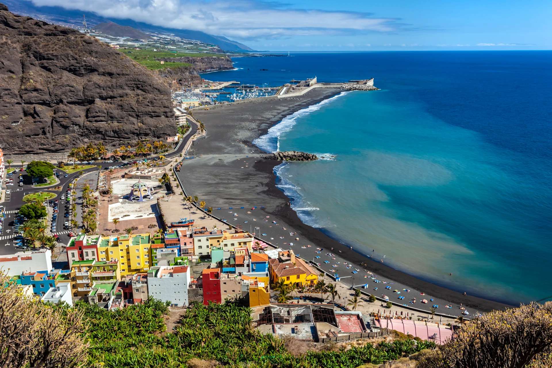 Colourful La Palma houses overlooking a dark blue body of water