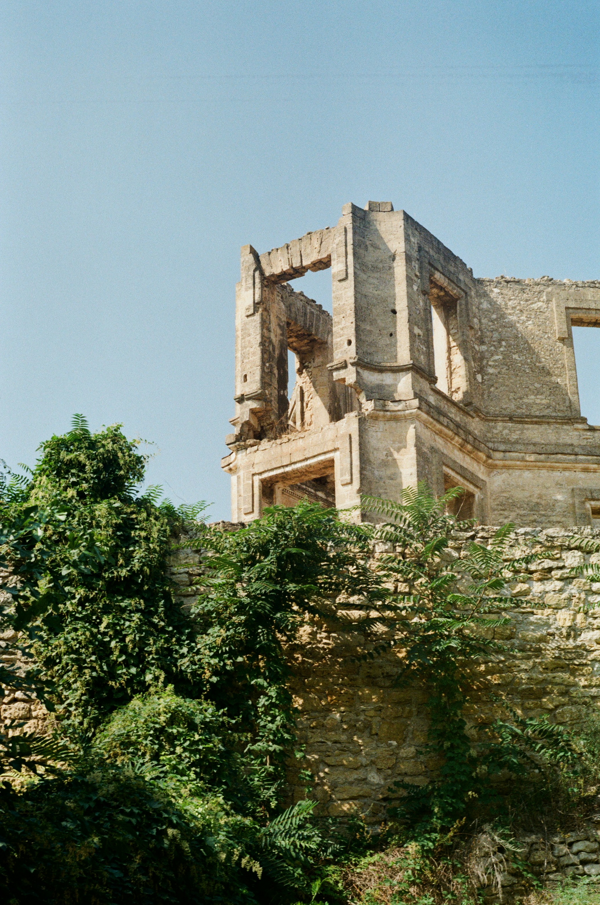 Brown concrete building near green trees during daytime photo