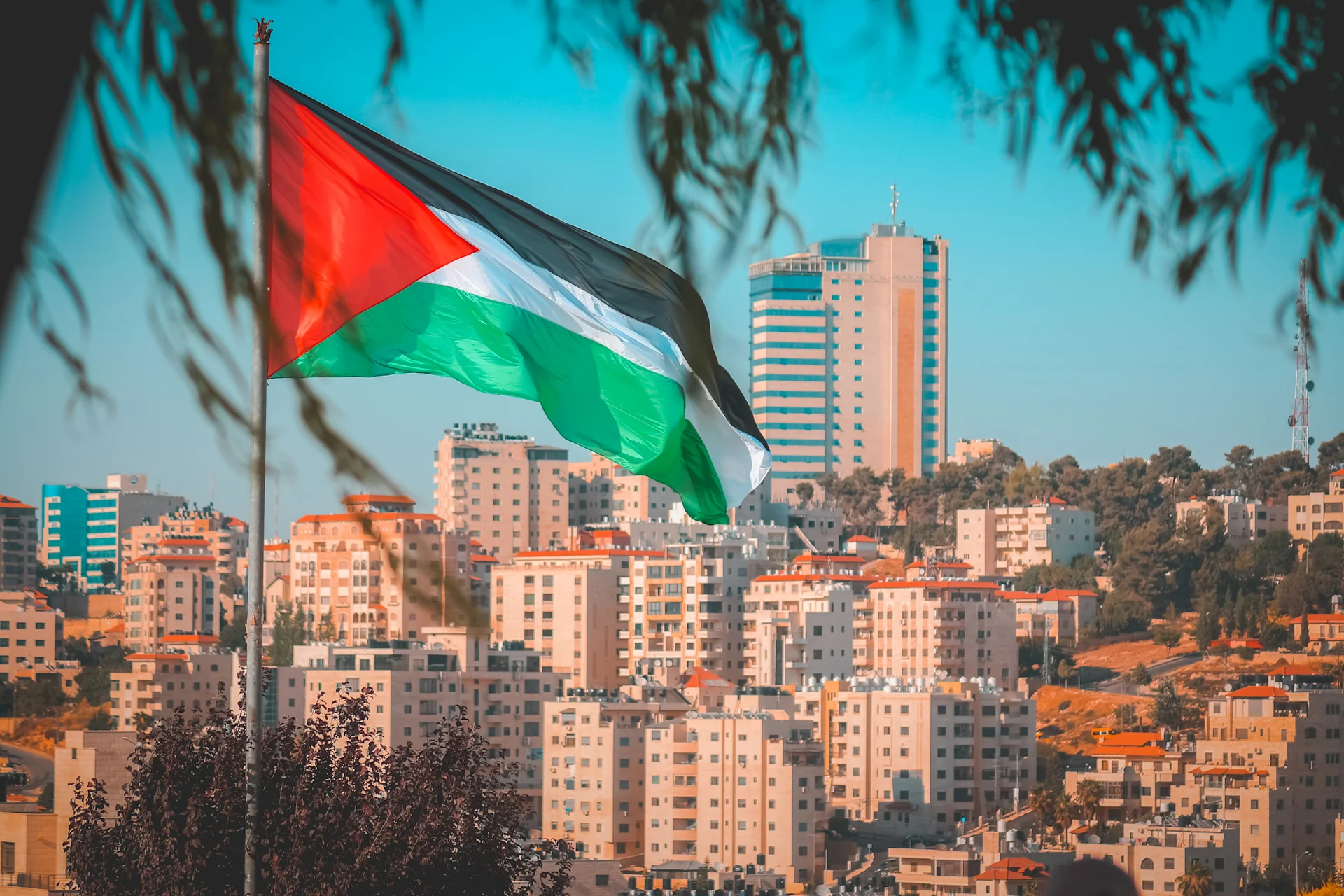 Palestine Authority flag flown before buildings in Palestine State
