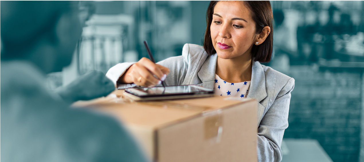 Woman signing for parcel at store
