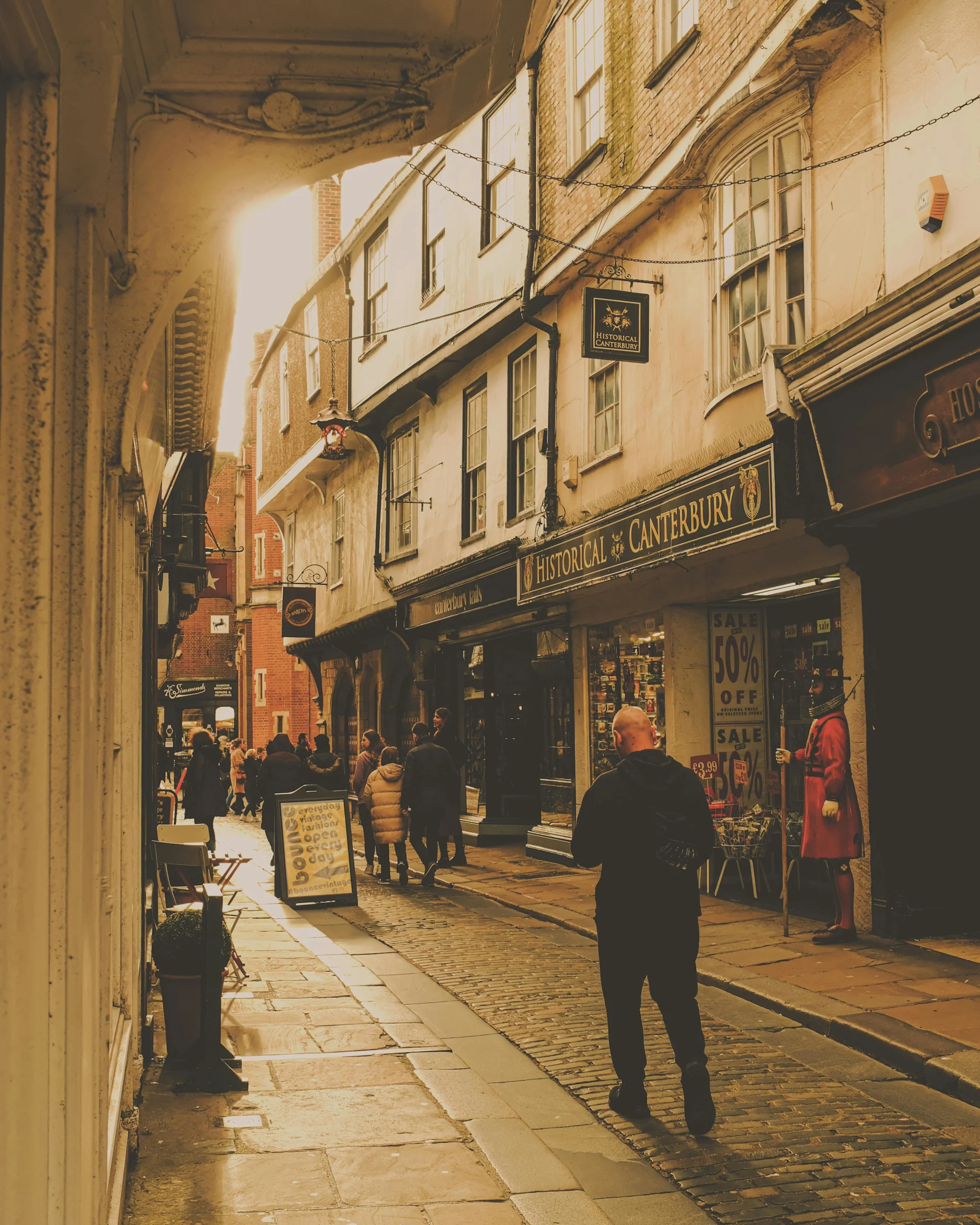 People Walking through an Old Town Shopping Street