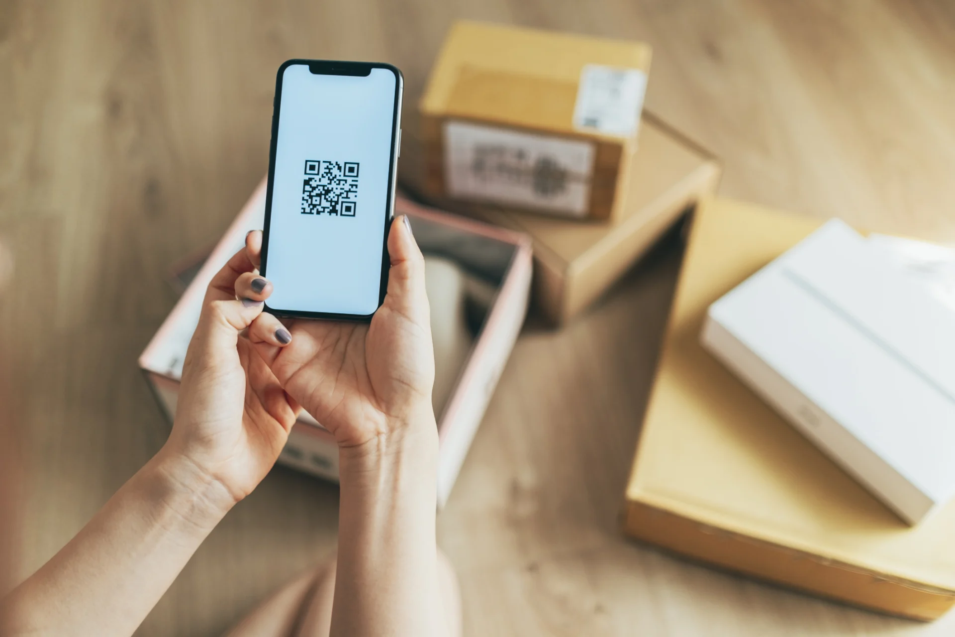 Person scanning parcel QR code with phone