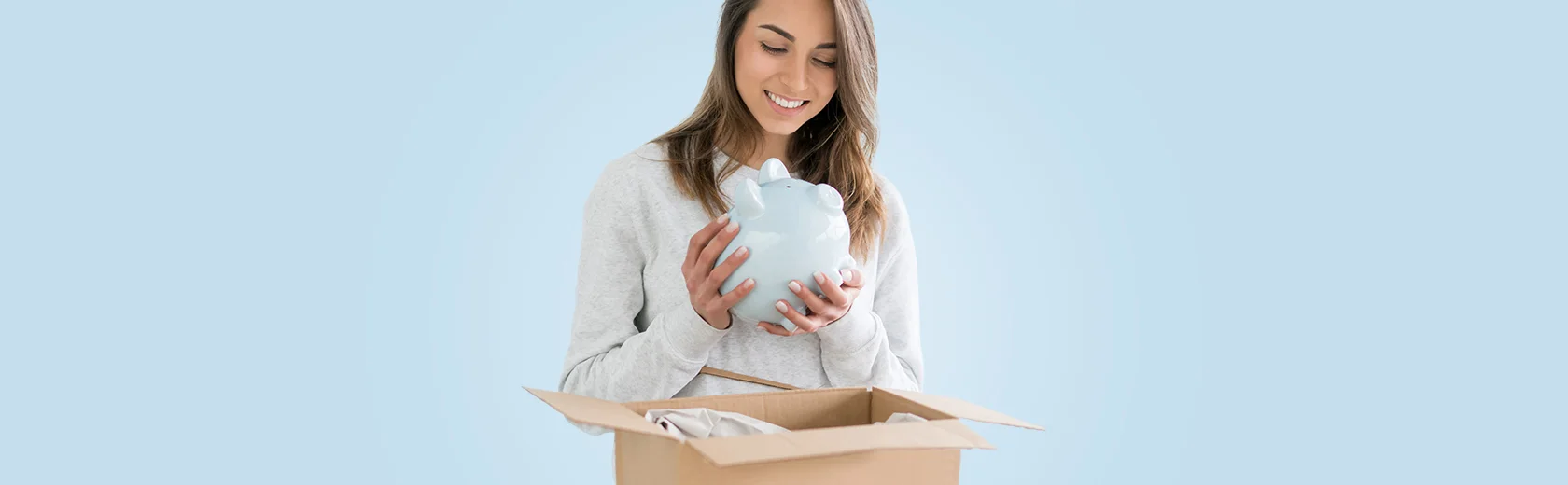 Woman taking piggy bank from parcel