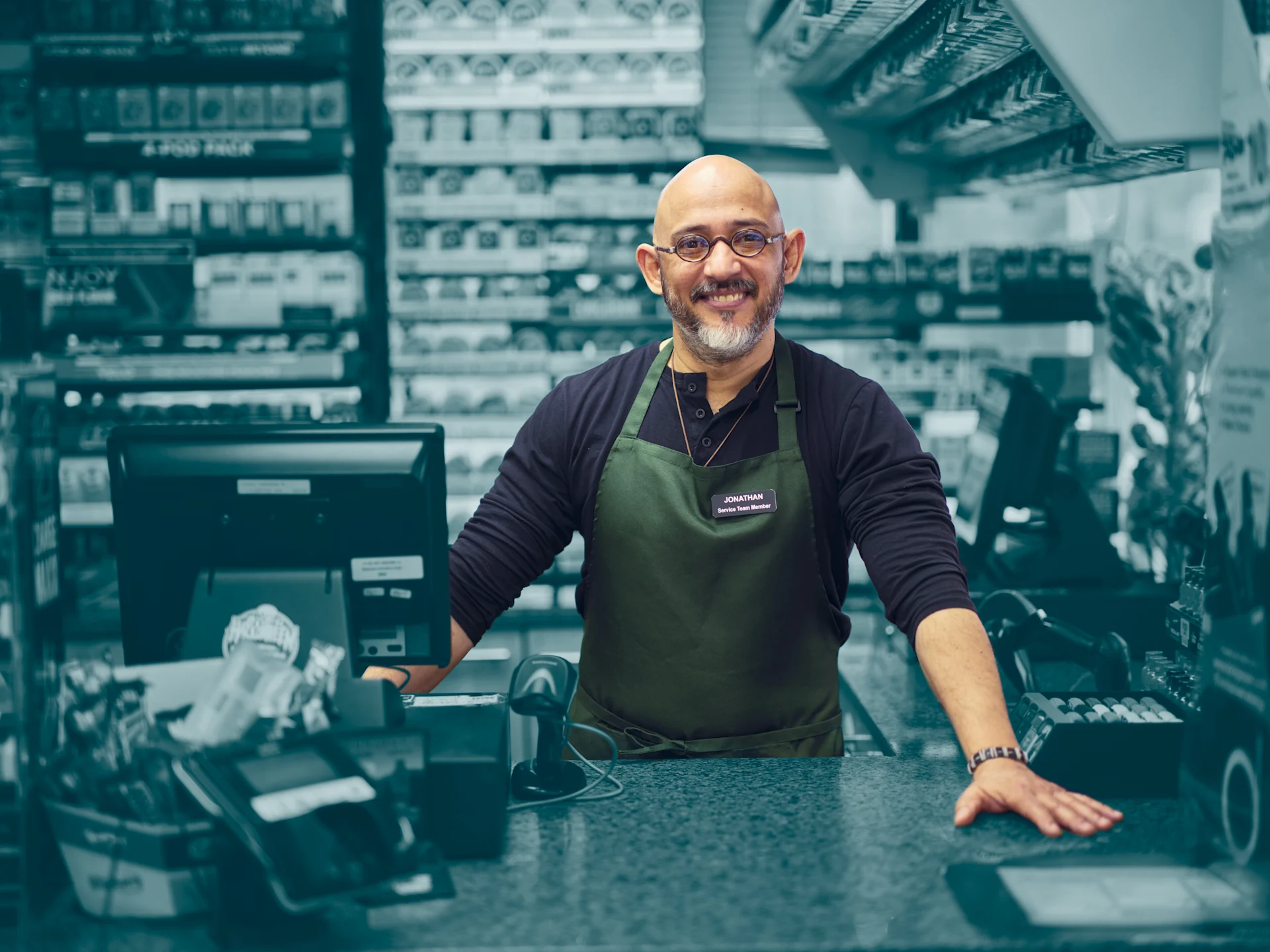 Man in shopping smiling over counter