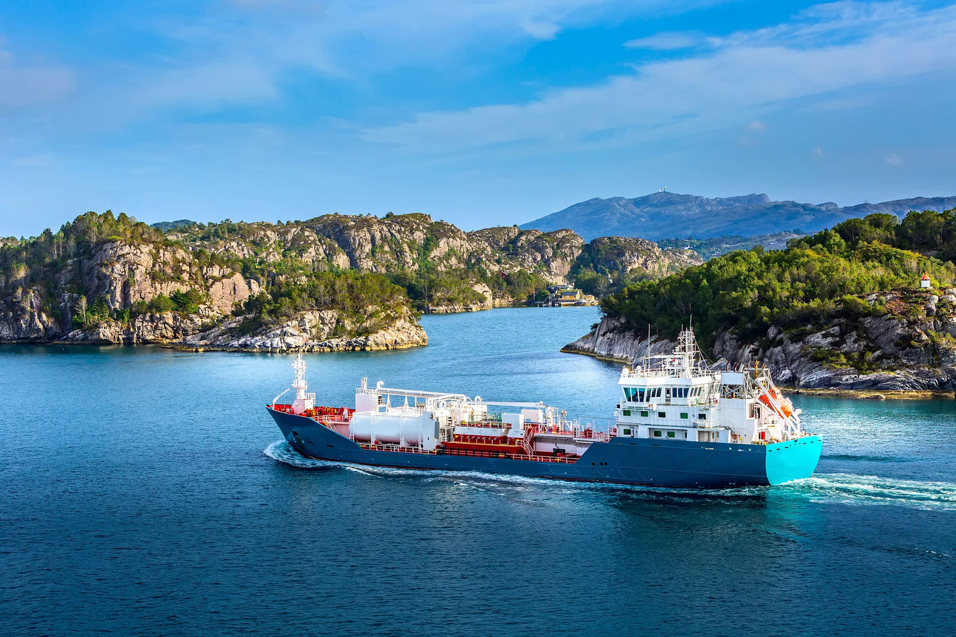 Large cargo boat between travelling between mountain ranges.